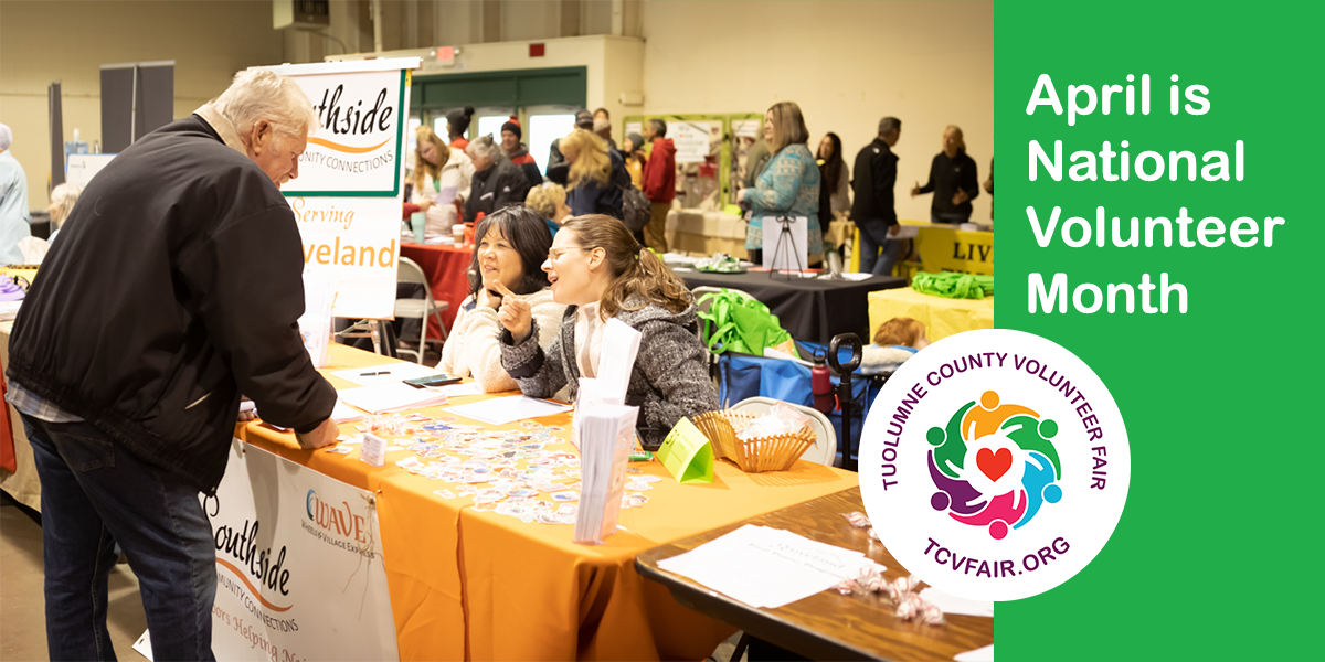 Man at Southside Community Connections booth at the Tuolumne County Volunteer Fair. The booth is staffed by two women laughing with the man.